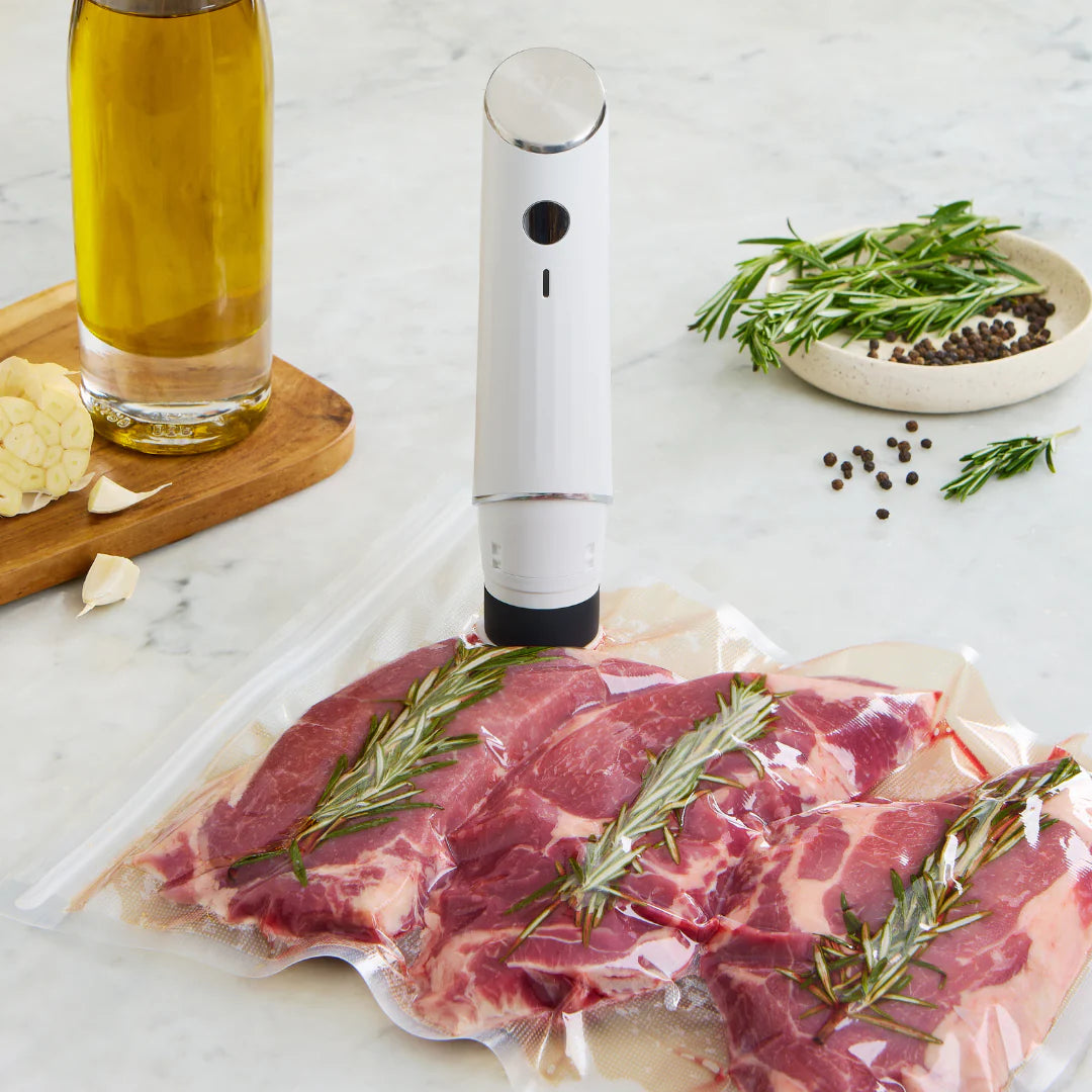 Chef Preserve vacuum sealer preserving raw steak with herbs in air-tight plastic bag
